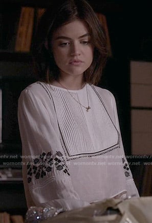 Aria’s white top with black embroidery on Pretty Little Liars