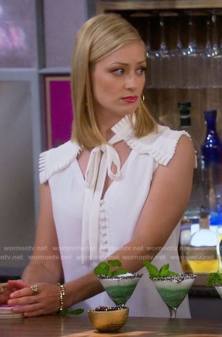 Caroline’s white tie neck top with pleated shoulders on 2 Broke Girls