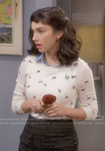 Mandy's bee print sweater and black skirt with front pockets on Last Man Standing