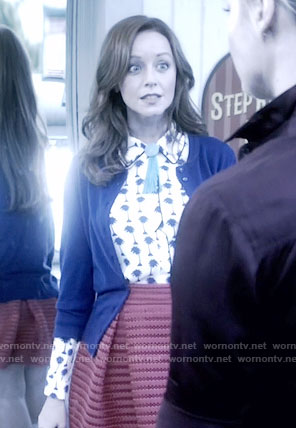 Cassandra's palm tree print shirt and red pleated skirt on The Librarians