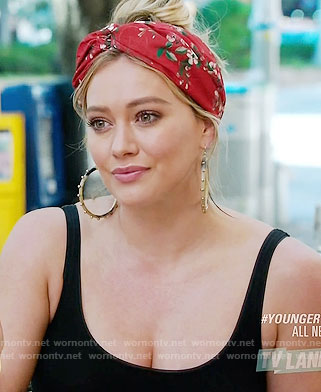 Kesley's red floral hair turban and studded hoop earrings on Younger