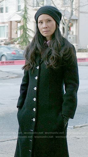 Joan’s long black coat with white buttons on Elementary