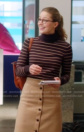 Kara’s striped turtleneck sweater and camel button-front skirt on Supergirl