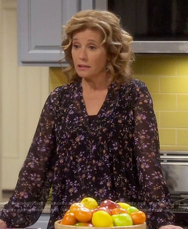 Vanessa’s black floral v-neck blouse on Last Man Standing