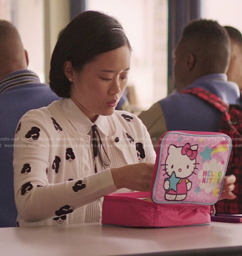 Courtney’s white face print cardigan and Hello Kitty lunchbox on 13 Reasons Why