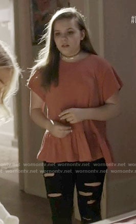 Daphne’s coral peplum tee on Nashville