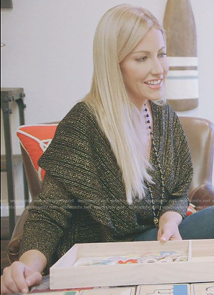 Stephanie's black and gold cross front sweater on The Real Housewives of Dallas