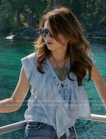 Haley's blue ruffled lace-up top on Modern Family