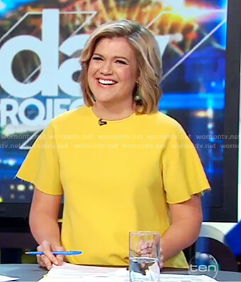 Sarah’s yellow short sleeve top on The Project