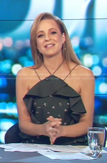 Carrie’s green off shoulder studded ruffle dress on The Project