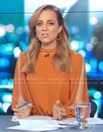 Carrie's orange long slit sleeve top on The Project