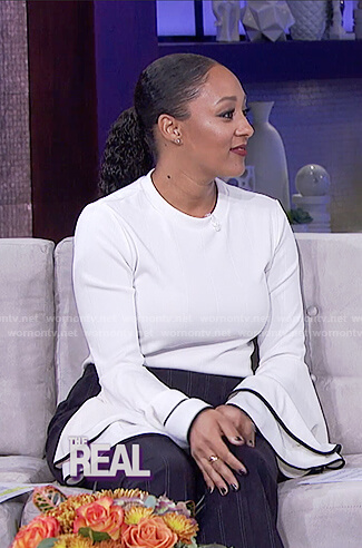 Tamera’s white tiered bell sleeve top on The Real