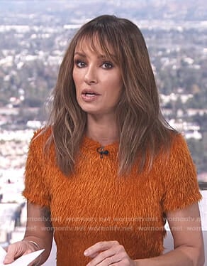 Catt’s orange fluffy short sleeve top on E! News Daily Top