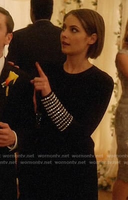 Thea's black dress with embellished cuffs on Arrow