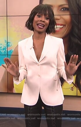 Zuri’s white lace-up blazer and leather pants on E! News