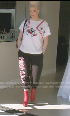 Erika's white racing cat print tee and fame kills pants on The Real Housewives of Beverly Hills