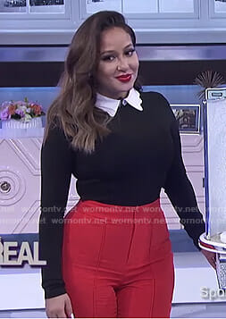 Adrienne’s black scalloped collar top and red pants on The Real