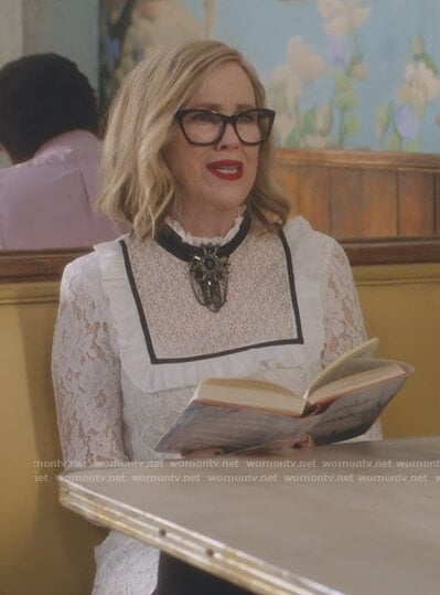 Moira’s white bib front lace dress on Schitt’s Creek