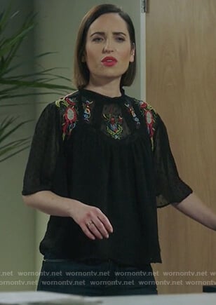 Jen’s black short sleeve embroidered top on Life in Pieces