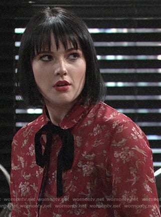 Tessa’s red floral blouse with velvet tie neck on The Young and the Restless