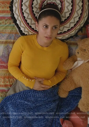 Ana's yellow pearl embellished cuff sweater on Grown-ish