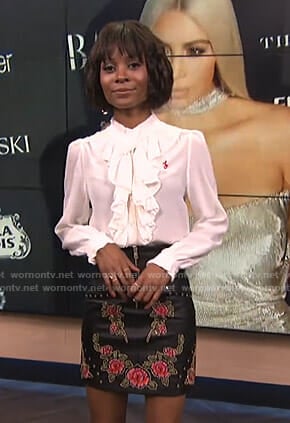 Zuri’s white ruffled blouse and floral mini skirt on E! News