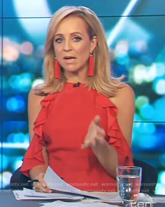 Carrie’s red cold shoulder ruffle jumpsuit on The Project