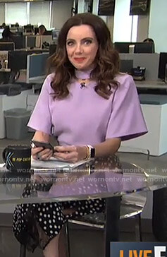 Melanie’s purple cutout top and black polka dot skirt on Live from E!