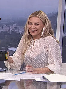 Morgan’s white dotted tie neck top on E! News Daily Pop