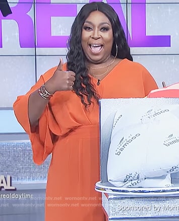 Loni's orange v-neck jumpsuit on The Real