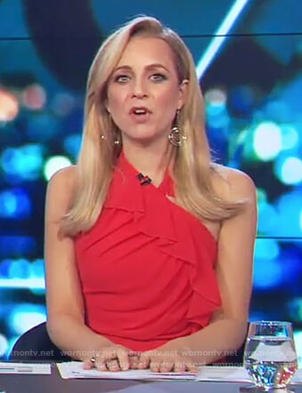 Carrie’s red halter neck ruffle dress on The Project