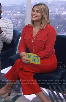 Carissa’s red shirt with white stitching and cropped pants on E! News Daily Pop