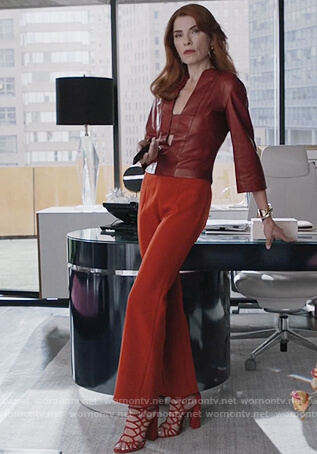 Kitty's red leather split neck top and orange pants on Dietland