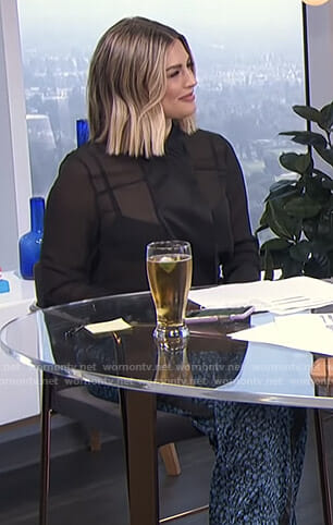 Carissa’s black sheer blouse and printed pants on E! News Daily Pop