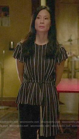 Joan's striped asymmetric top on Elementary