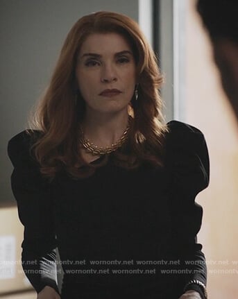 Kitty's black puff shoulder sweater on Dietland