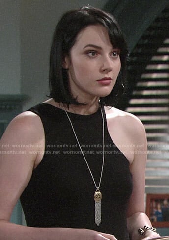 Tessa’s black asymmetric top and fringed pendant necklace on The Young and the Restless