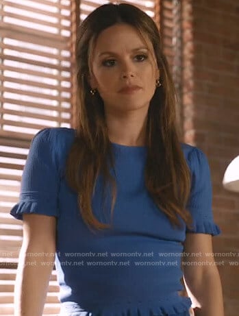 Sam’s blue ruffled short sleeve top on Take Two