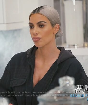 Kim’s black zip front hooded jacket on Keeping up with the Kardashians