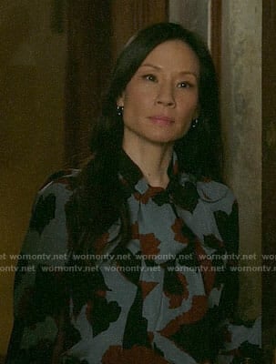 Joan's blue printed tie-neck blouse on Elementary