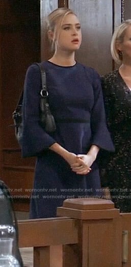 Kiki’s navy bell-sleeve dress with black trim on General Hospital