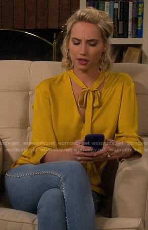 Mandy’s yellow tie neck blouse and studded jeans on Last Man Standing