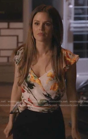 Sam’s white floral wrap top on Take Two