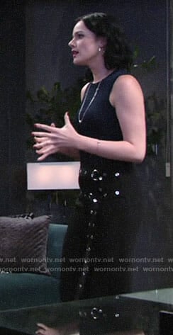 Tessa’s navy top and black double belted pants on The Young and the Restless