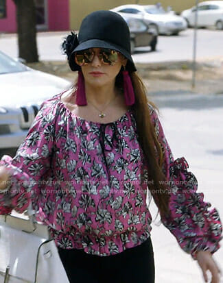 D’Andra’s pink floral ruffle blouse on The Real Housewives of Dallas