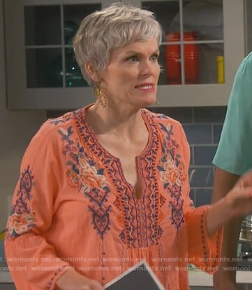 Bonnie’s orange floral embroidered top on Happy Together