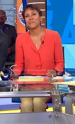 Robin’s orange blouse and side striped pants on Good Morning America