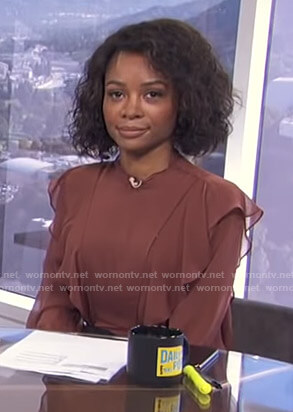 Zuri’s brown ruffled blouse on E! News Daily Pop