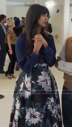 Tahani's navy blouse and floral high-low skirt on The Good Place