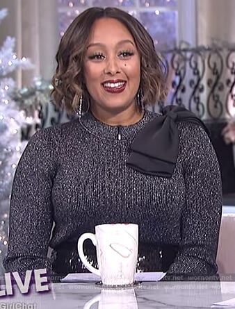 Tamera’s black metallic bow shoulder sweater on The Real